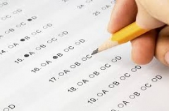 a persons hand holding a pencil completing a form